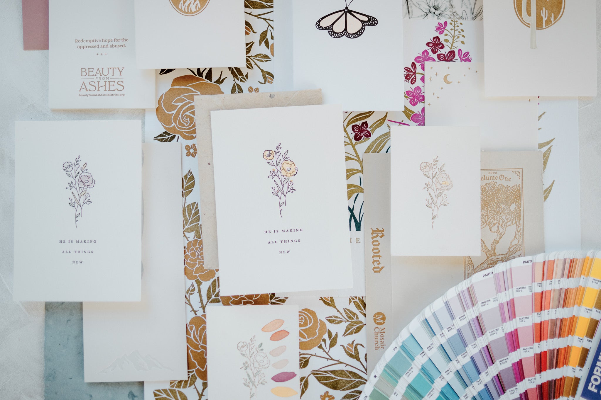 Colorful flat lay arrangement of letterpress art prints and brand designs